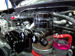 Mishimoto prototype of oil sandwich plate installed with banjo fittings
