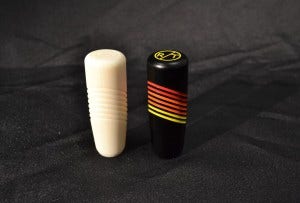 A view of our 3D printed prototype shift knob next to the final product.