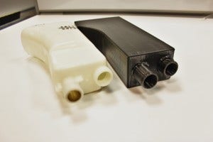 Stock expansion tank (left) and 3D-printed Mishimoto expansion tank prototype (right)