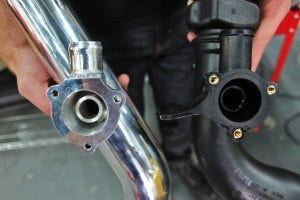 Mishimoto hot-side intercooler pipe BPV flange (left) and stock BPV flange (right)