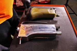 Mishimoto expansion tank (bottom) and stock expansion tank (top)