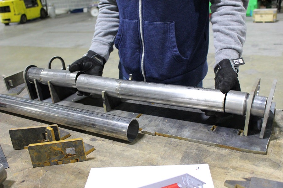 Mustang H-pipe pieces resting in the jig