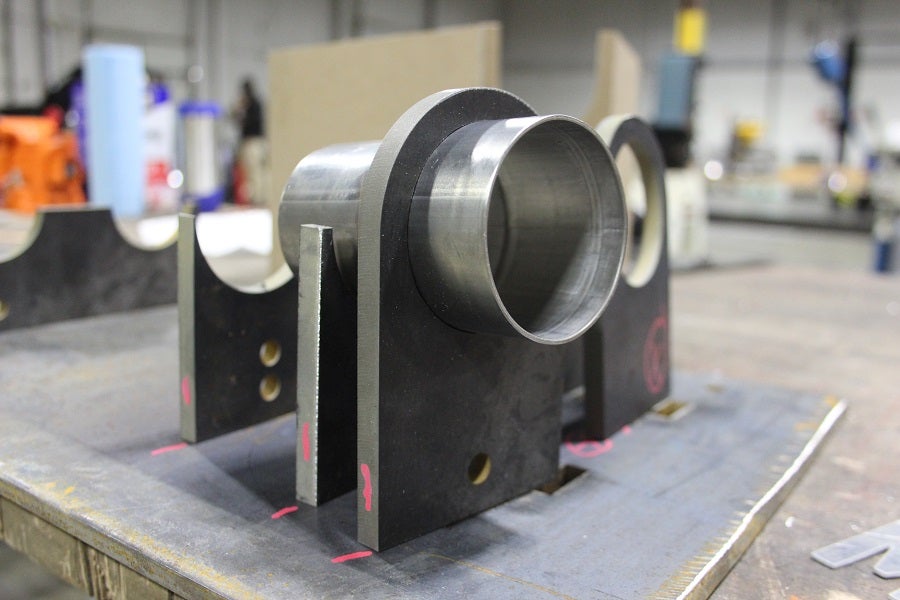 Mustang H-pipe pieces resting in the jig