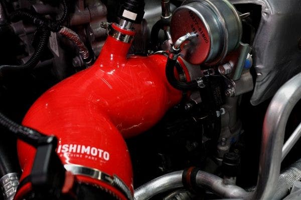 The elbow connects directly to the turbo and has an attachment for the PCV hose