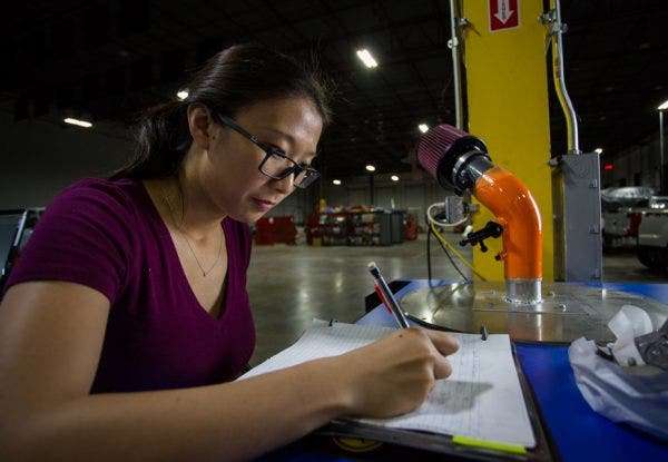 Ye works diligently testing the flow characteristics of our prototype on our flow bench using 3D printed components.