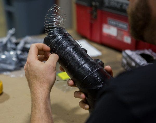 A metal reinforcement wire is added to the hose between layers to keep the hose from collapsing under a heavy vacuum created by the turbo. Specifically, the wire is added on the straight points around the ports.