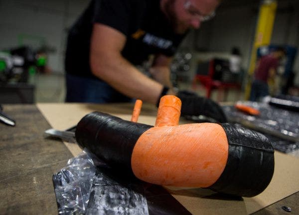 For the most part, silicone hoses incorporate several layers of material. Mike starts laying the first layer directly on to the mold before adding the other necessary layers and materials.