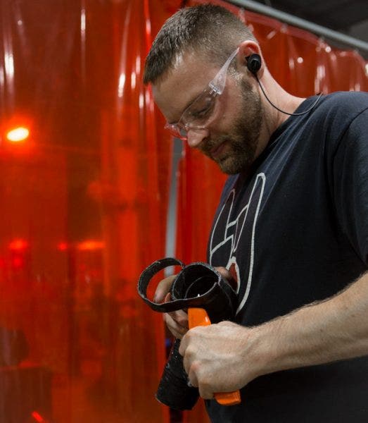 After the silicone is cured, Mike uses the cut lines that are now imprinted on the inside of the hose to trim the excess material. Once the edges are trimmed, Mike just needs to grind down the edges and it's ready for testing.