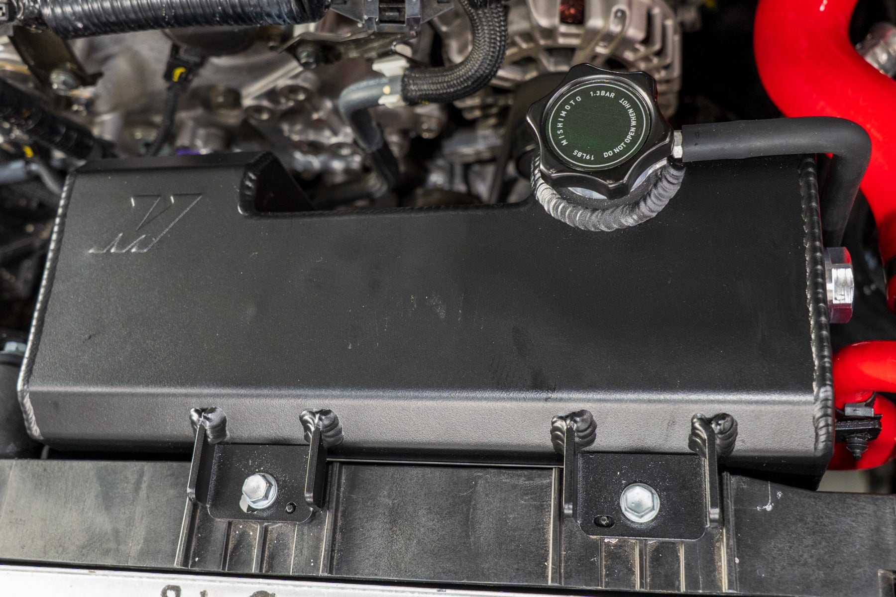 Aluminum reservoir tank installed in the engine bay of the 2024+ Toyota Tacoma.