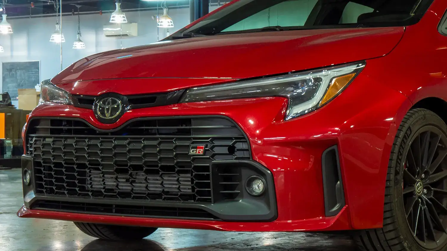 An image of the front grille of a red 2023 Toyota GR Corolla.