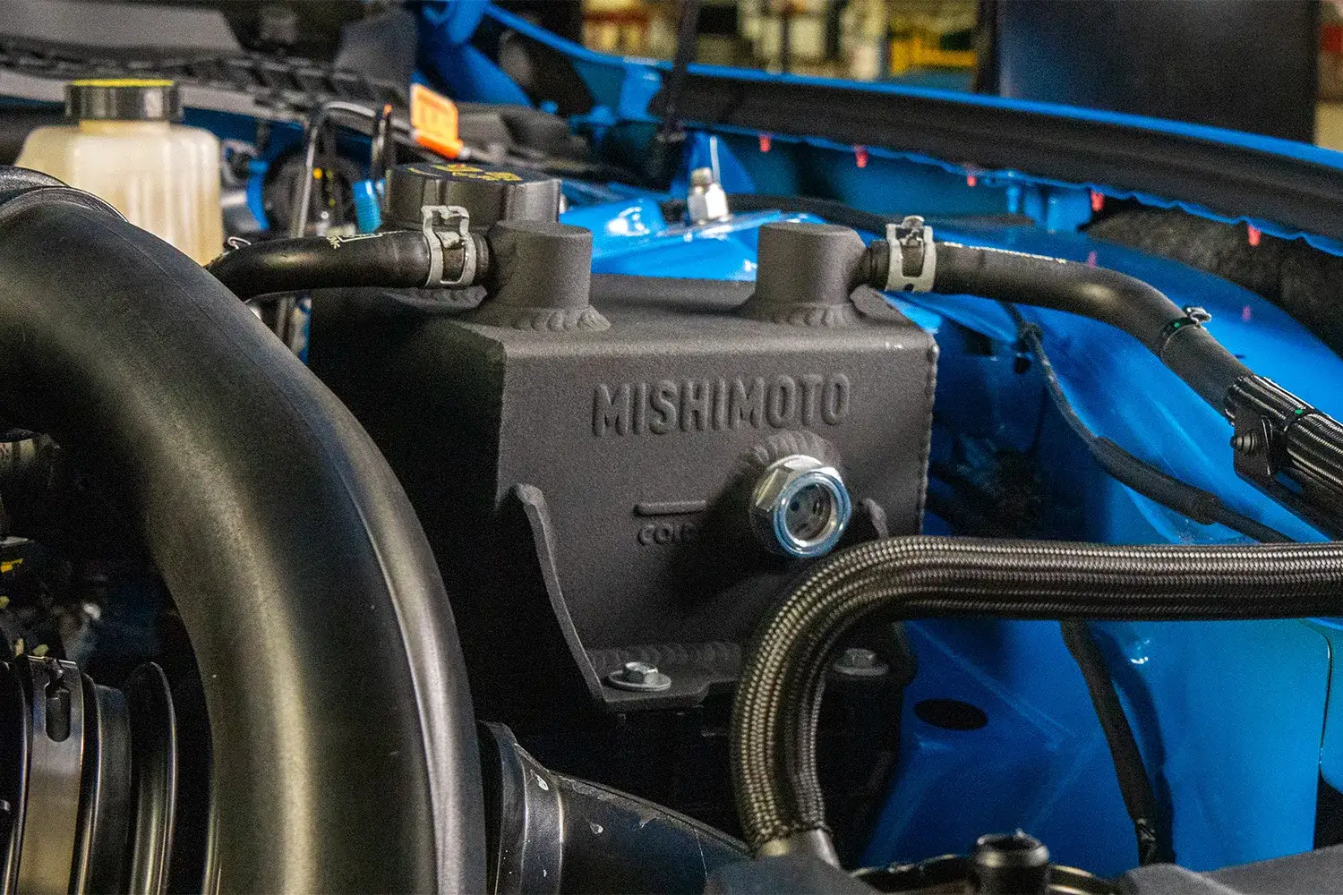 Image of the Mishimoto Aluminum Coolant Expansion Tank installed in the engine bay of a 2024+ Ford Mustang EcoBoost