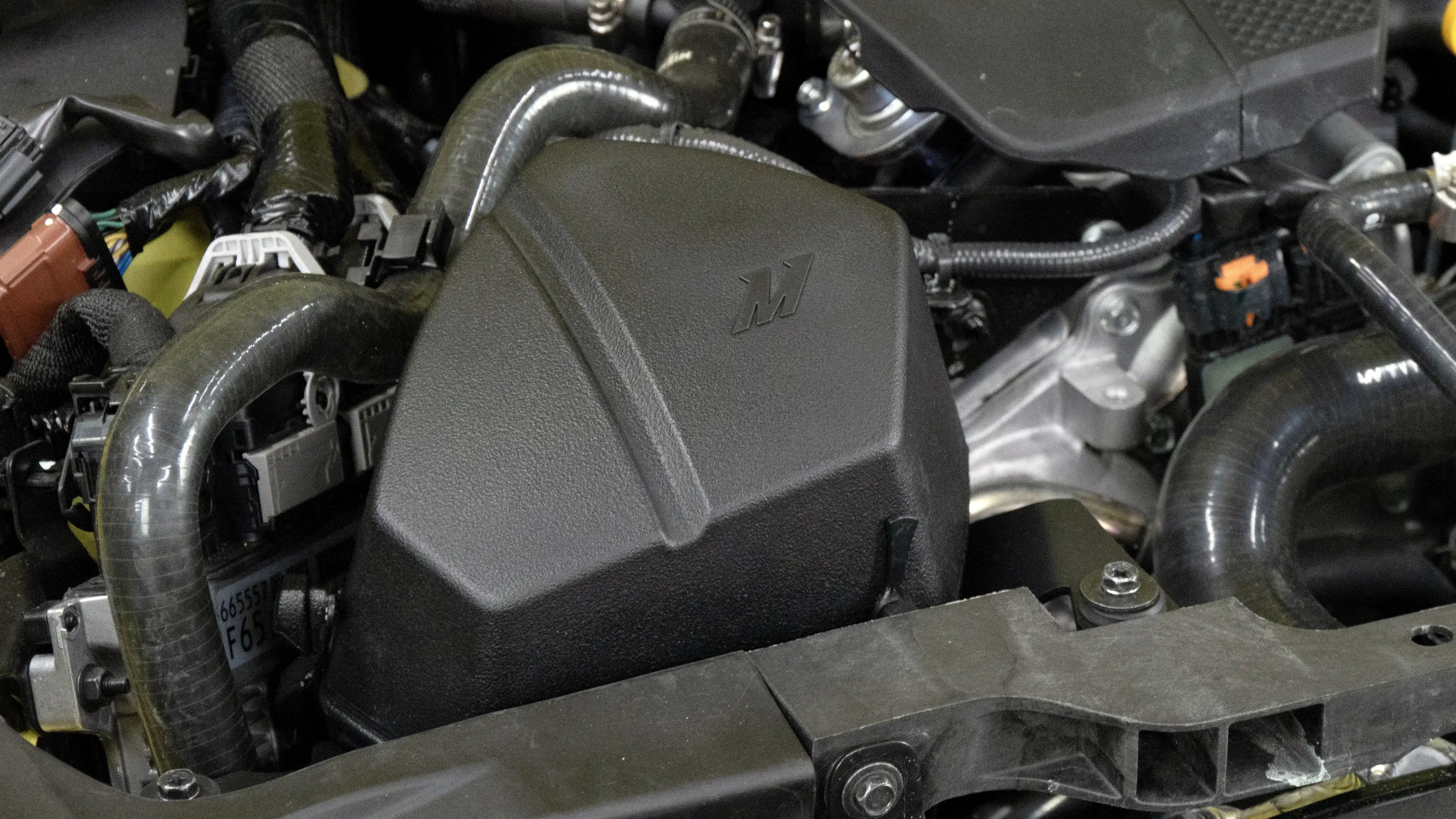 A close-up image showing the Mishimoto intake installed with the top half secured.